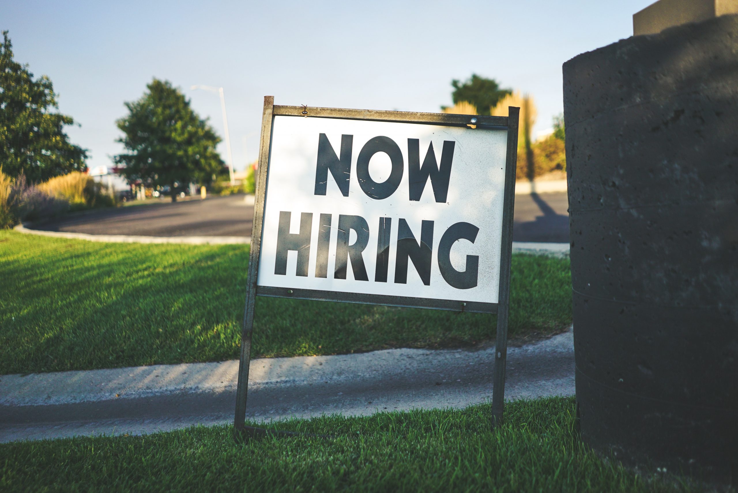 white and black now hiring signage