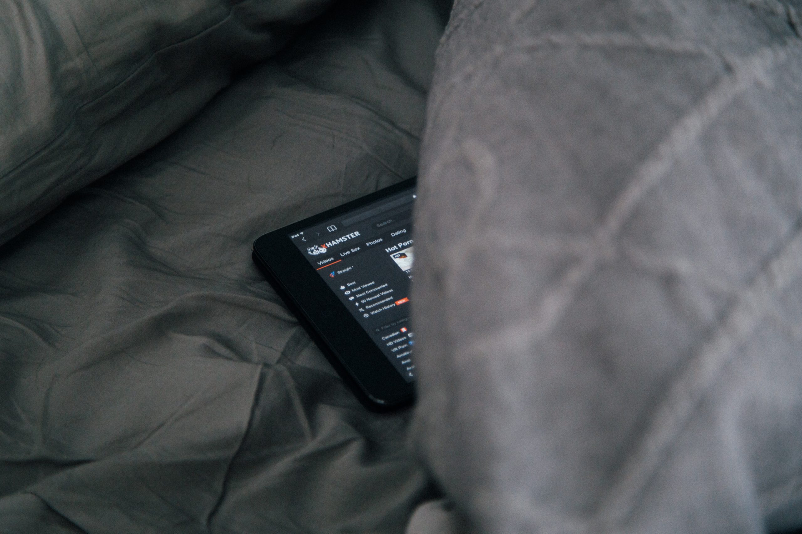 black Android smartphone on gray sheet