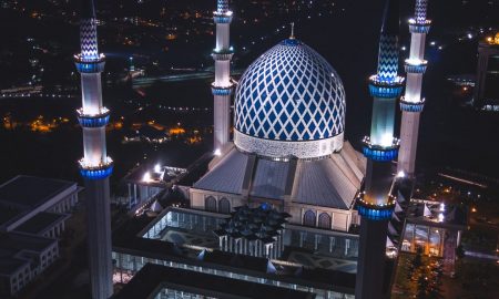 white and blue dome concrete building with 4-towers during night time