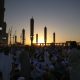 people standing near high rise building during sunset