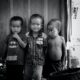 2 boys standing near wooden door