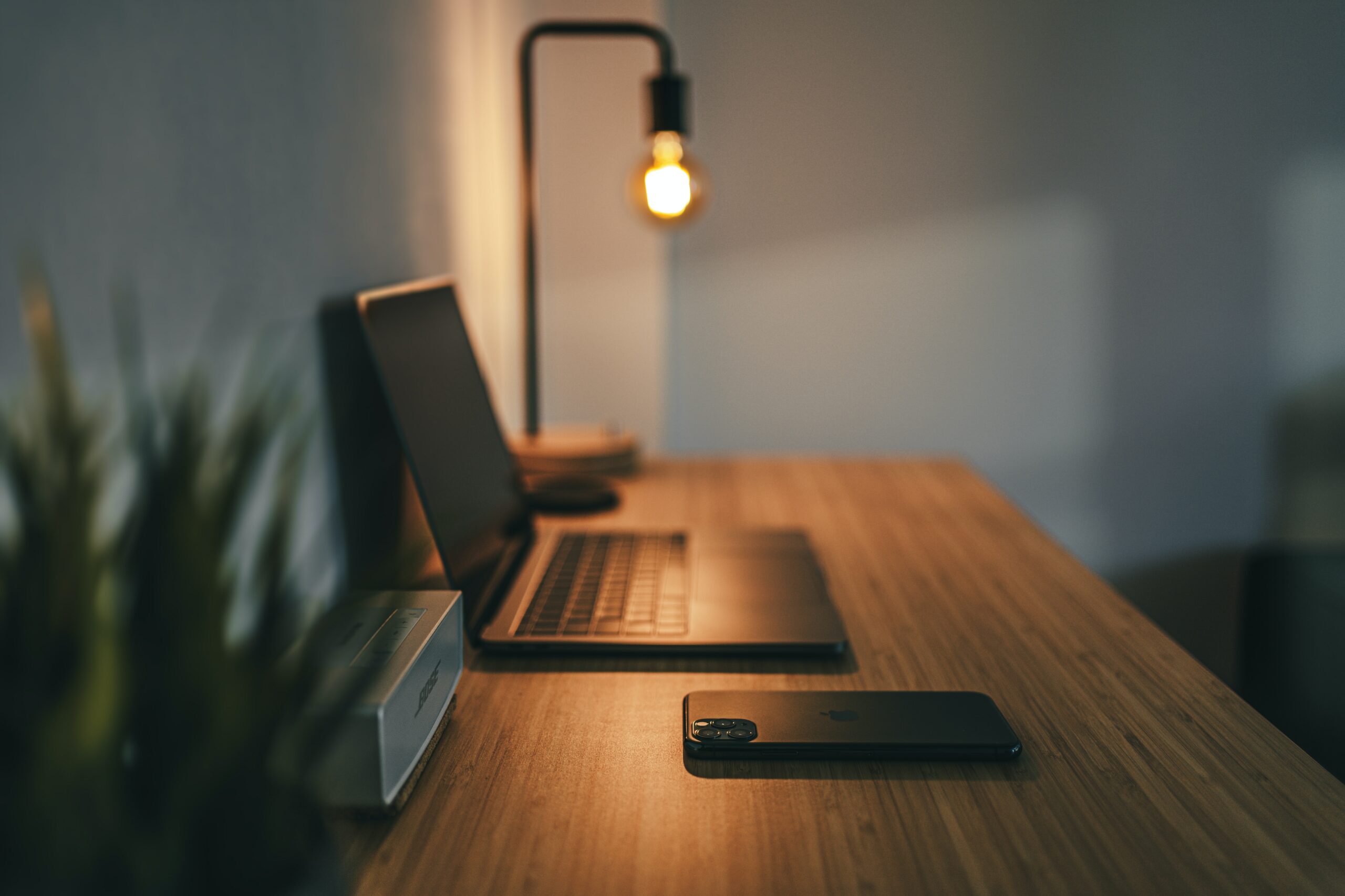 black laptop computer on brown wooden table