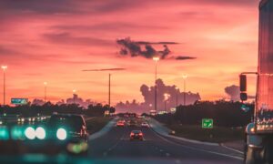 cars on road in sunset
