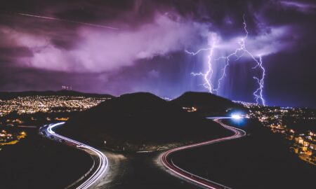 time lapse photography of road and mountains during night time