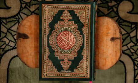 black and red book on brown wooden table