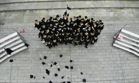 group of graduates throwing academic hats