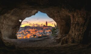 brown cave with over-view of city