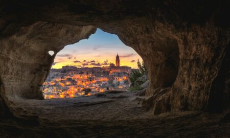 brown cave with over-view of city