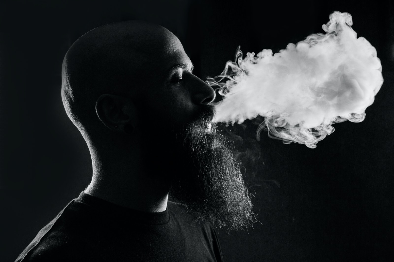 man smoking with black background