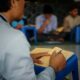 man in white dress shirt reading book