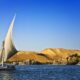 white sailboat on water under blue cloudy sky during daytime photo