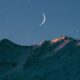 crescent moon above mountain