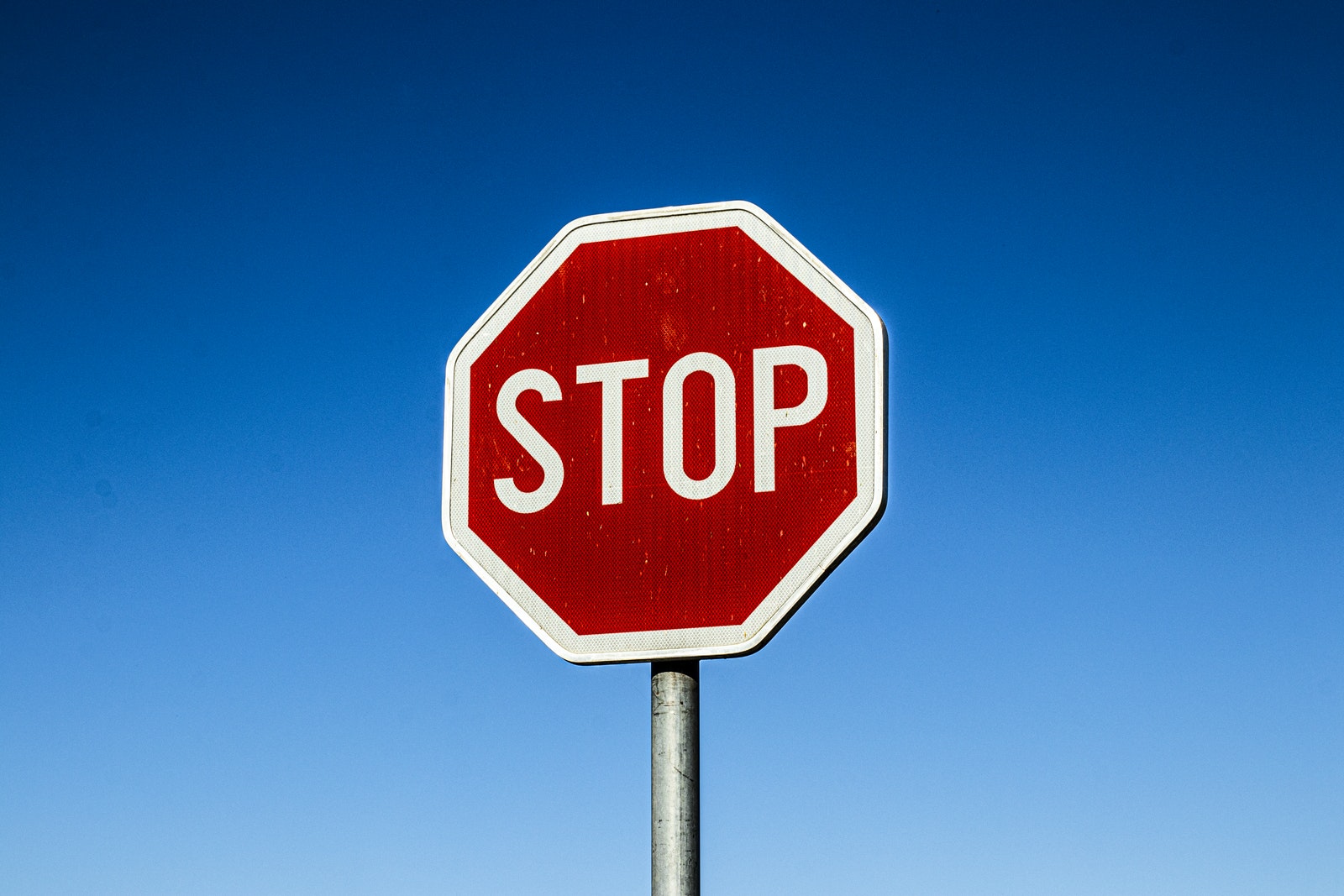 Red Stop Road Sign Under Blue Sky