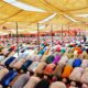 people bowing down inside canopy during day