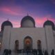 low-angle photography of a prayer temple under a purple sky