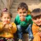 Three Children Sitting On Stairs