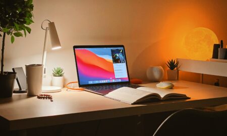 macbook pro on white wooden desk