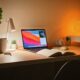 macbook pro on white wooden desk