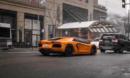 orange coupe on road