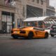 orange coupe on road