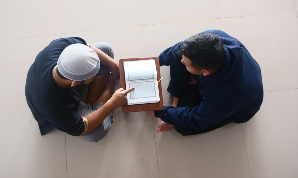 a couple of men looking at a tablet