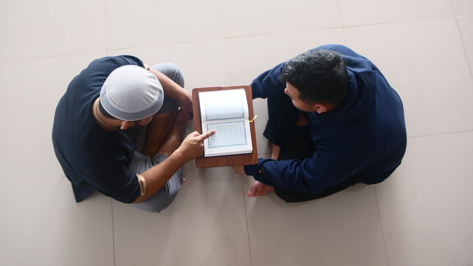 a couple of men looking at a tablet