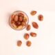 a glass bowl filled with nuts on top of a table