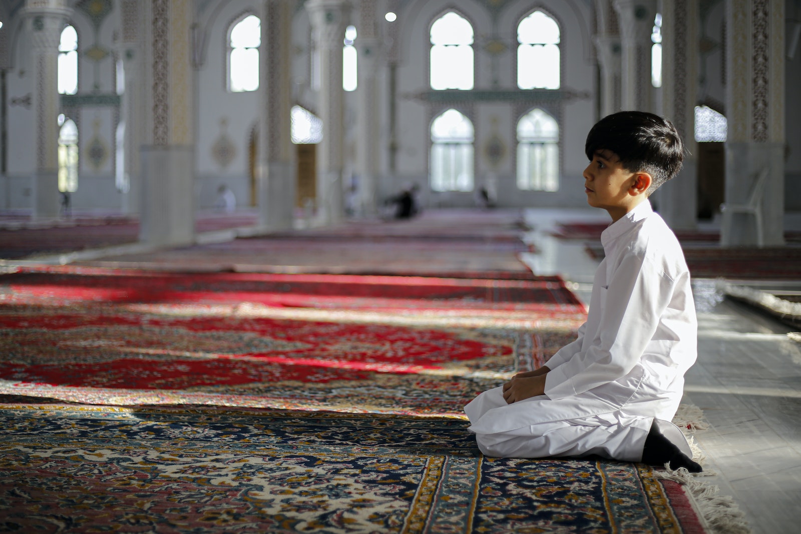 Boy Kneeling in Mosque