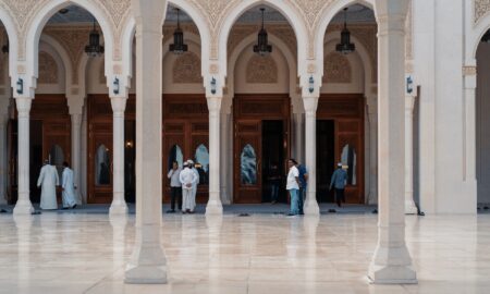 people walking at gray concrete pillared building