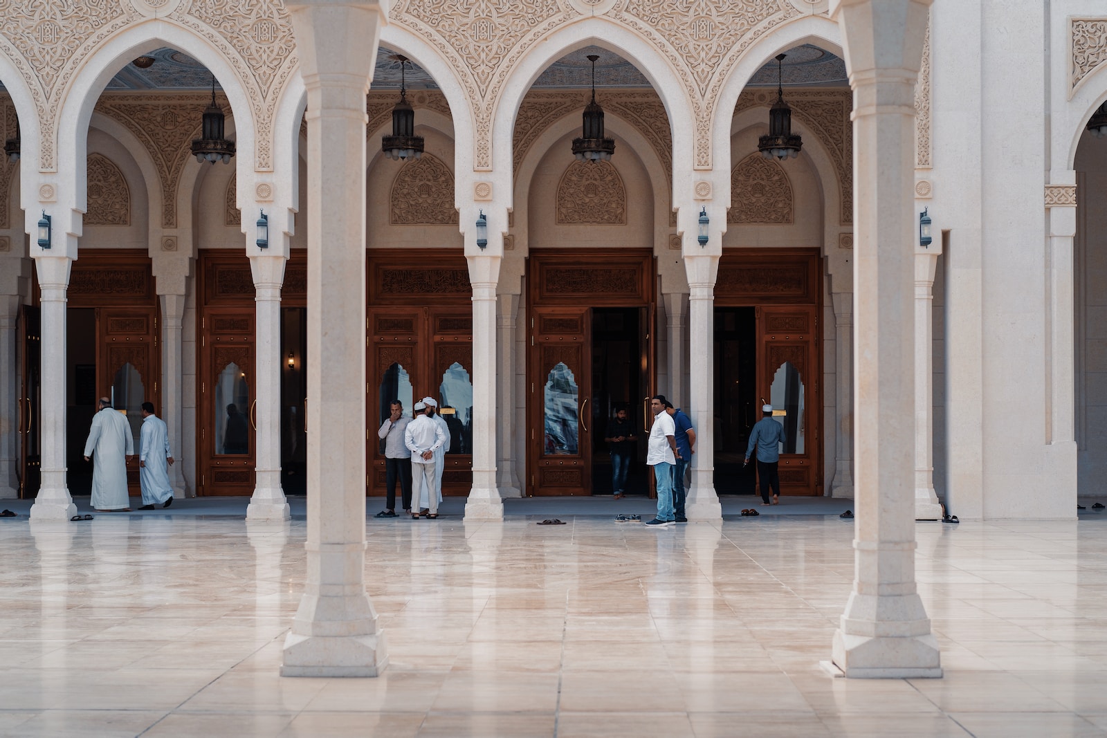 people walking at gray concrete pillared building