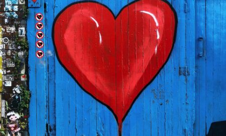 blue wooden gate with a red heart painted on it