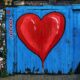 blue wooden gate with a red heart painted on it