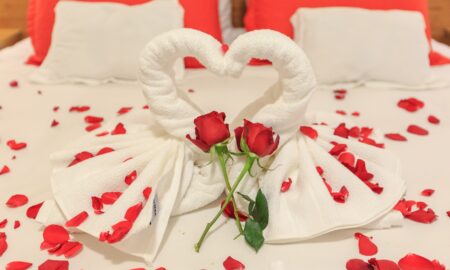 Red Roses and Bath Towels on a Bed