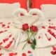 Red Roses and Bath Towels on a Bed