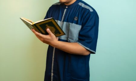 a man holding a book in his hands