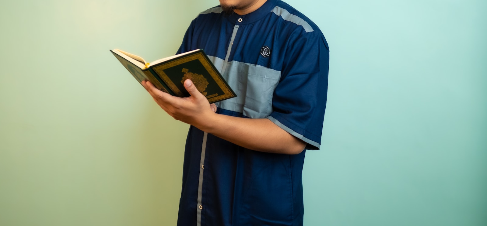 a man holding a book in his hands