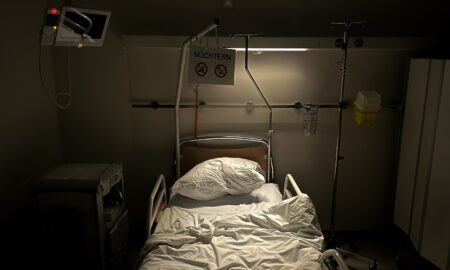 a hospital room with a bed and a monitor