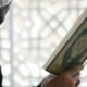 a close up of a person holding a book