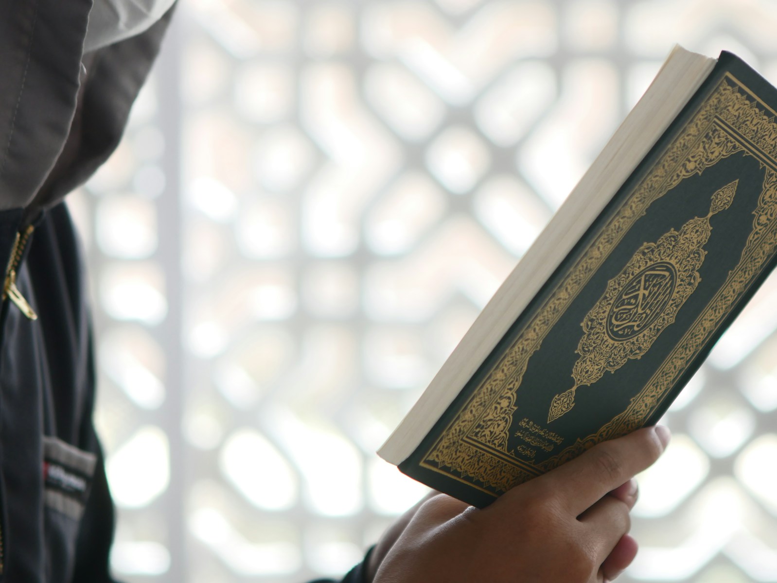 a close up of a person holding a book