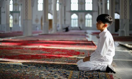 Boy Kneeling in Mosque