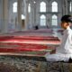 Boy Kneeling in Mosque