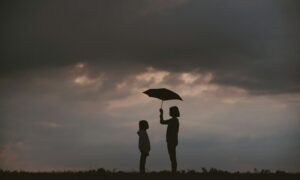 girl holding umbrella on grass field