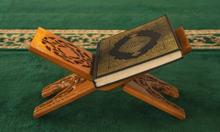 A wooden cross with a book on top of it