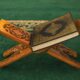 A wooden cross with a book on top of it